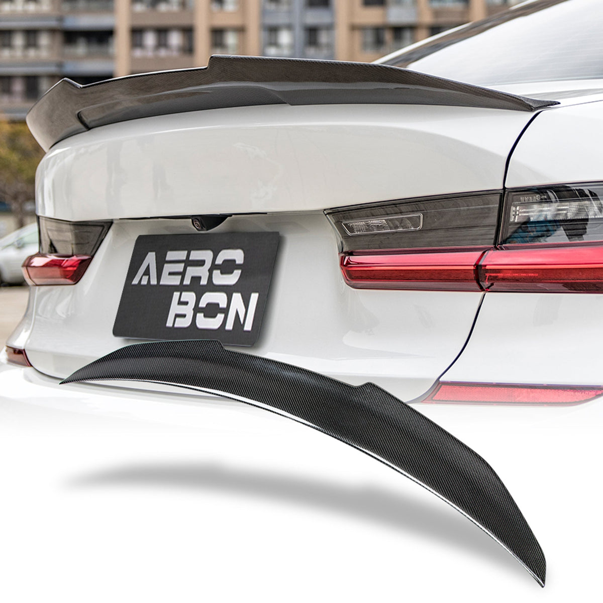 Carbon fiber trunk spoiler showing 3K twill weave and gloss clear coat