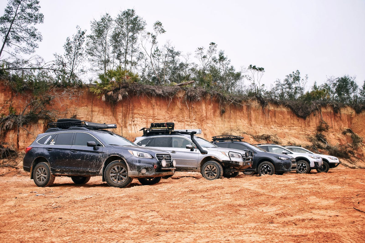 Lineup of new SUVs parked on a dirt road