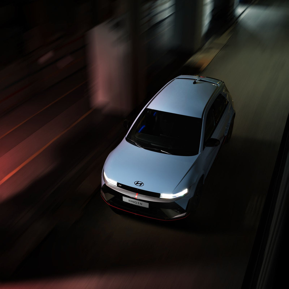 Hyundai Ioniq 5 driving on a city street at night