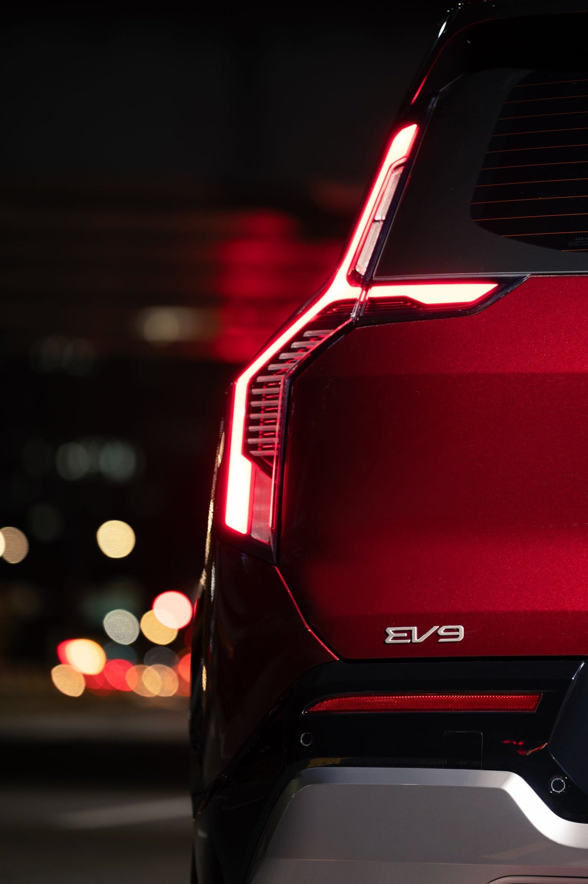 Kia three-row SUV driving at night