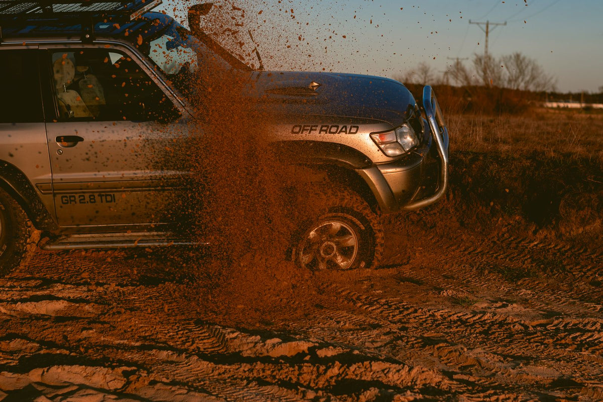 4x4 SUV driving on a sandy off-road trail