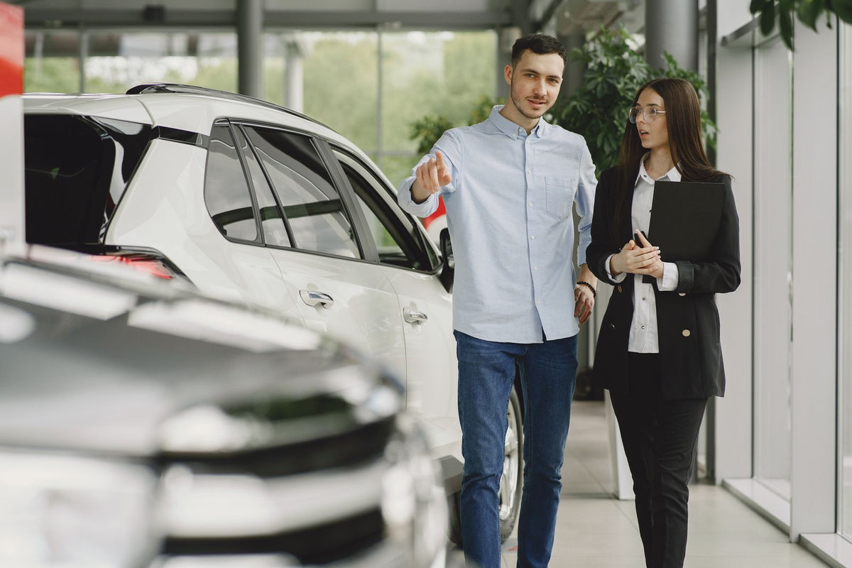 Customer discussing a vehicle with a dealership service advisor