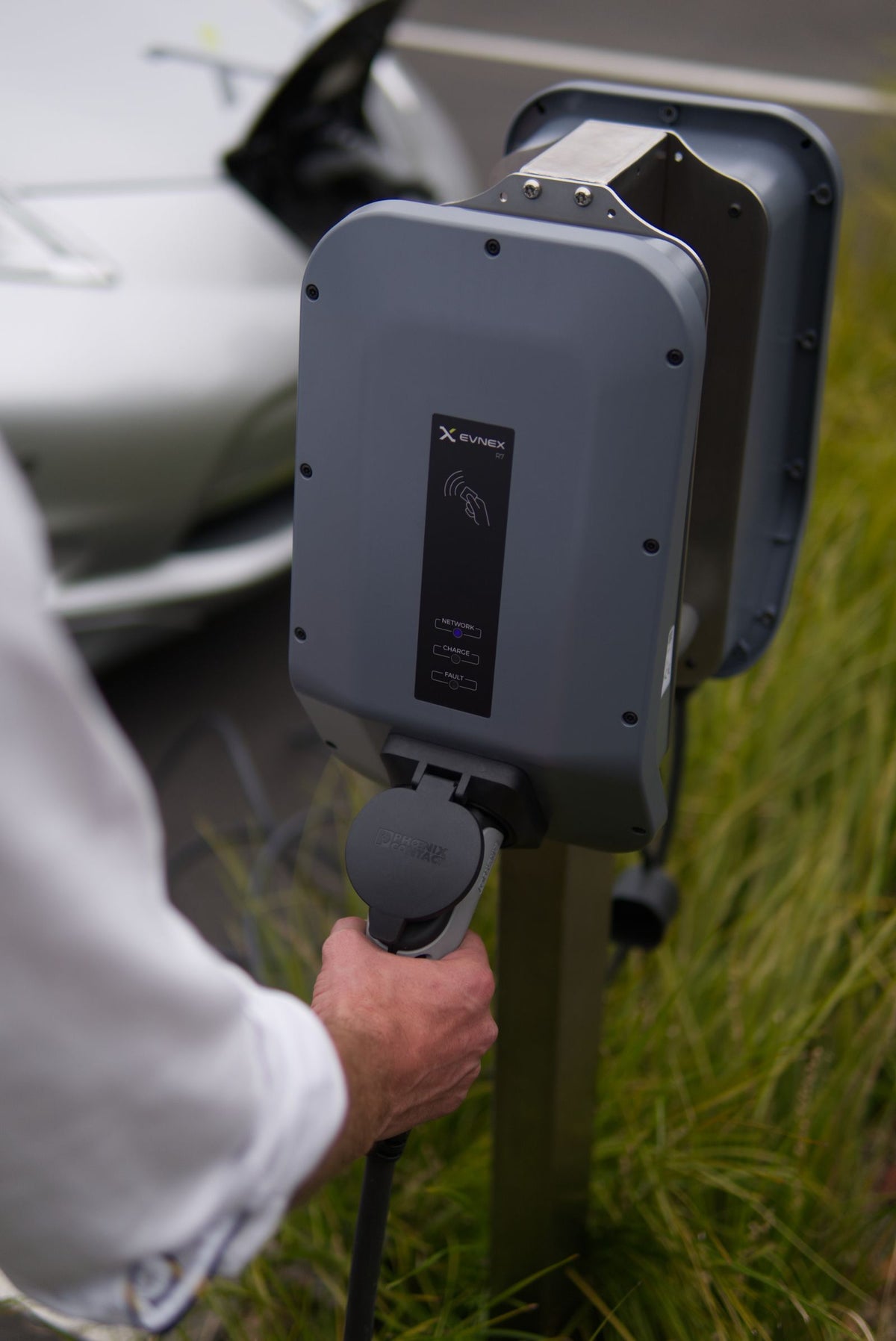 Driver connecting an electric vehicle charger