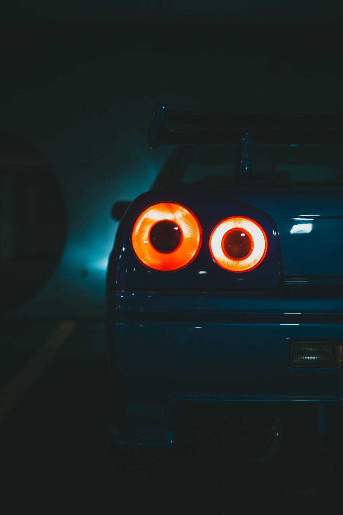 Round taillight of a Nissan Skyline at night